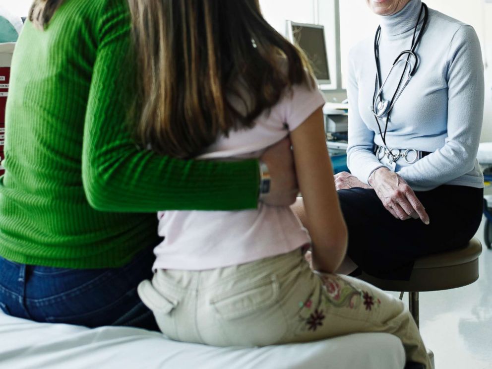 PHOTO: A mother and daughter speak with a doctor in an undated stock photo. 