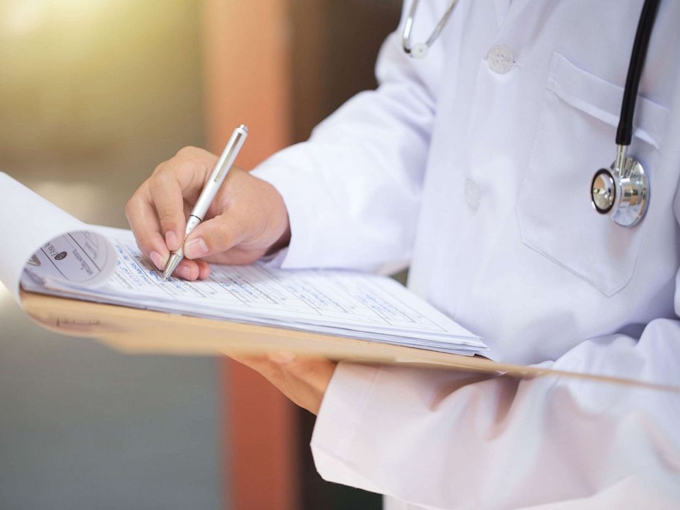 PHOTO: In this undated photo, a doctor makes notes on patient file.