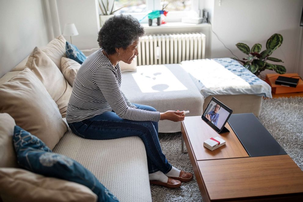 PHOTO: A woman holds a video conference with her doctor in this stock photo.
