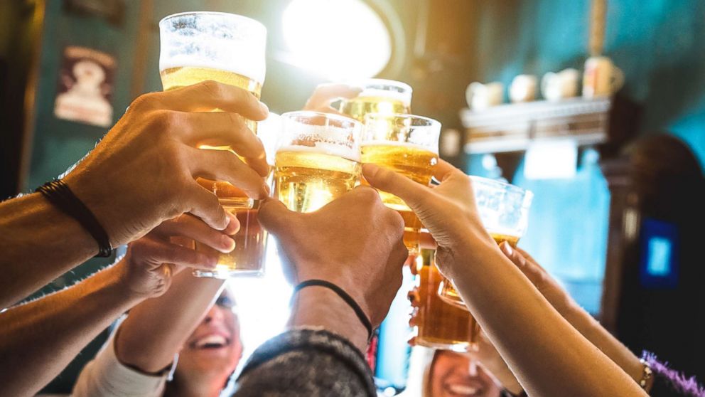 A group friends are pictured drinking and toasting beer in this undated stock photo.