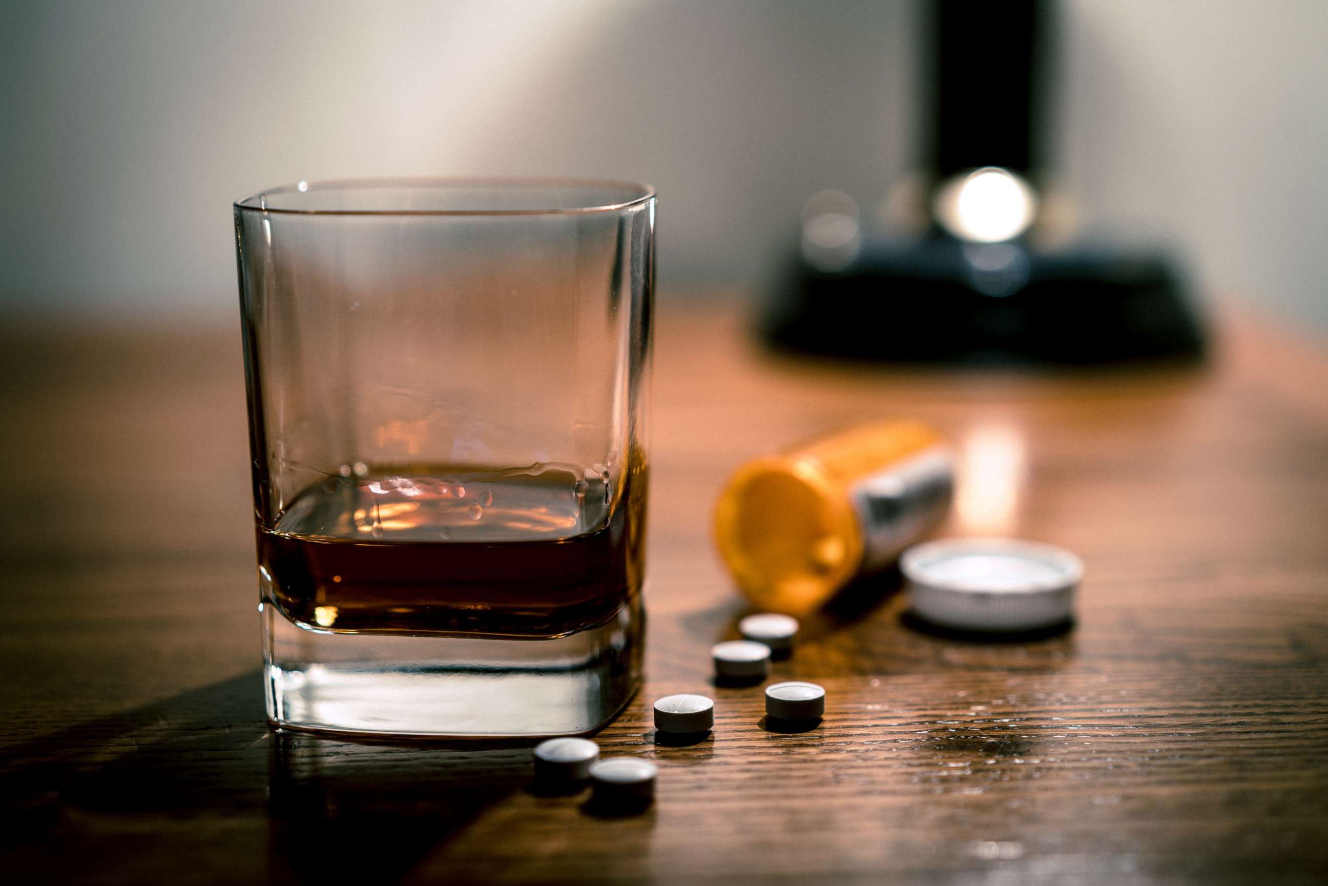 PHOTO: A glass of alcohol and some pills are seen on a table in this stock photo.