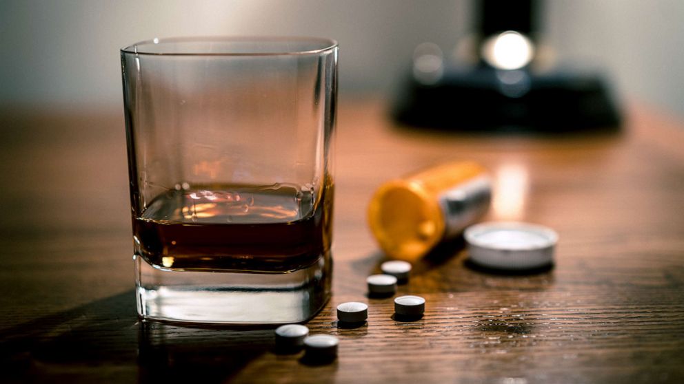 PHOTO: A glass of alcohol and some pills are seen on a table in this stock photo.