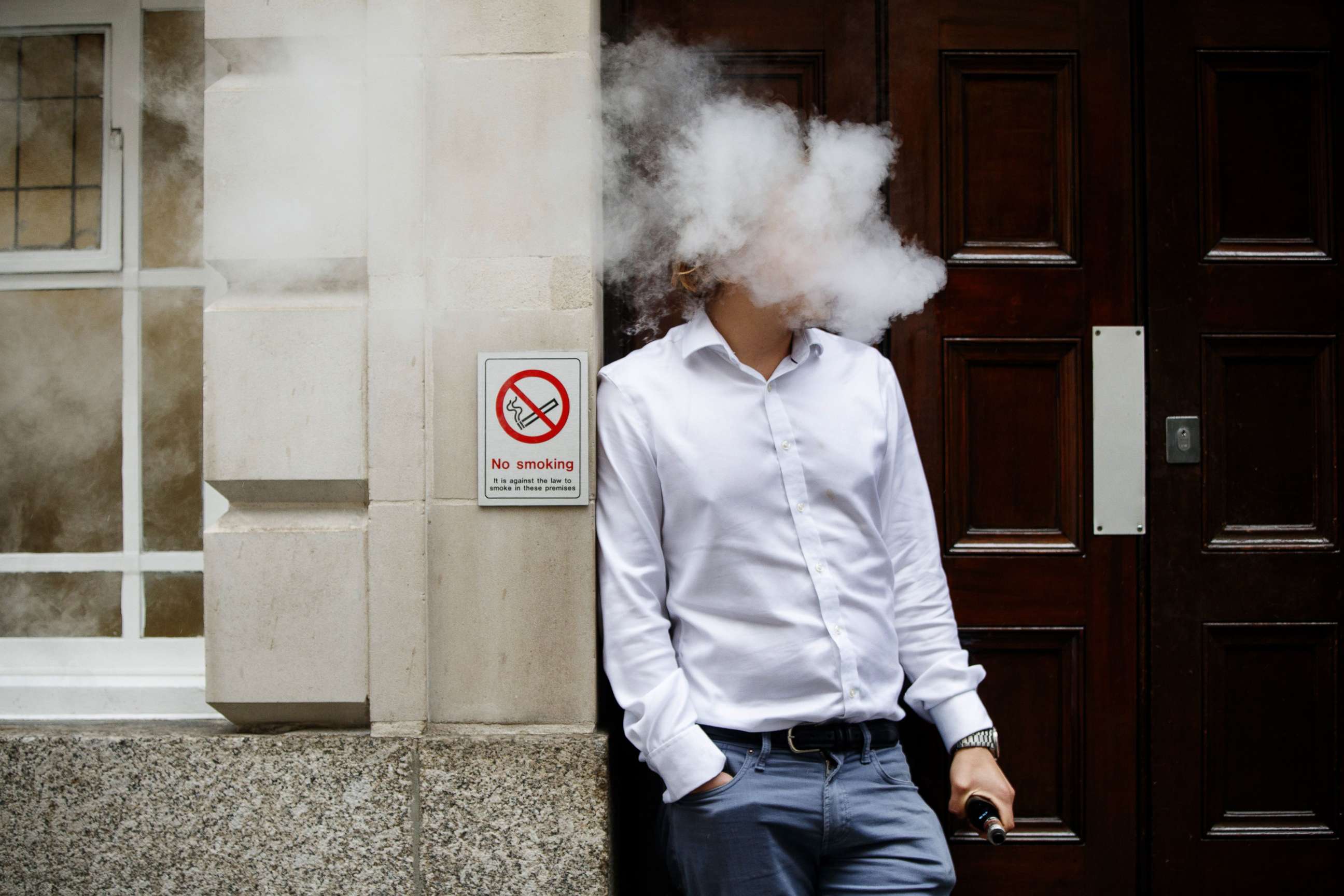 PHOTO: A smoker is engulfed by vapors as he smokes an e-cigarette during lunch time in central London, Aug. 9, 2017.