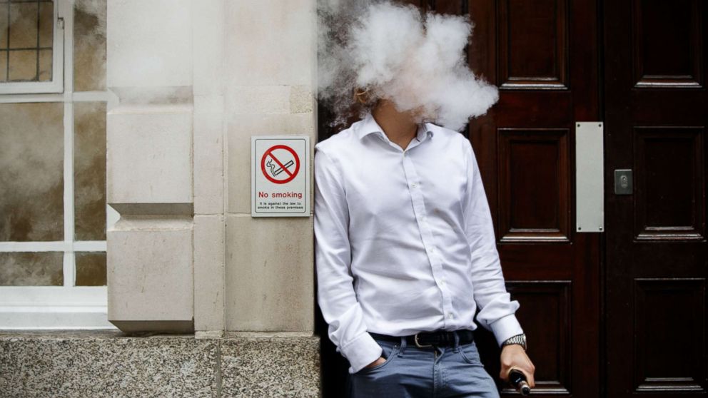 PHOTO: A smoker is engulfed by vapors as he smokes an electronic vaping machine during lunch time in central London, Aug. 9, 2017.