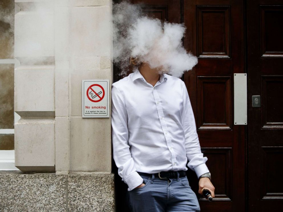 PHOTO: A smoker is engulfed by vapors as he smokes an e-cigarette during lunch time in central London, Aug. 9, 2017.