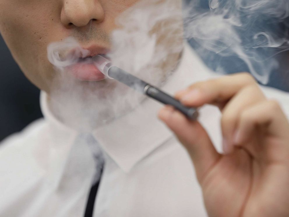 PHOTO: An attendant demonstrates Japan Tobacco Inc.s Ploom Tech smokeless tobacco device for a photograph during a media preview at the companys Ploom Shop Ginza in Tokyo, June 28, 2017.