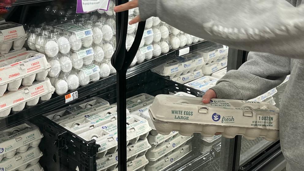 PHOTO: A customer picks up a dozen eggs to buy in a Giant grocery store in McLean, Virginia on Jan. 28, 2025. 