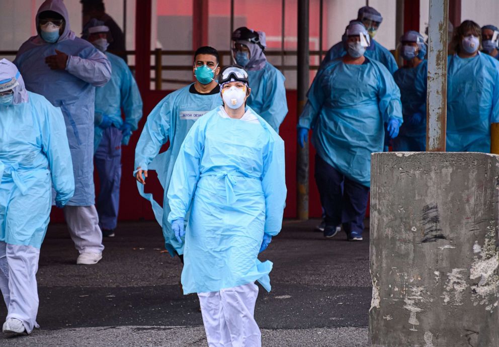 PHOTO: Medical workers walk outside the Elmhurst Hospital Center Emergency Room during the coronavirus pandemic, April 20, 2020, in New York City.