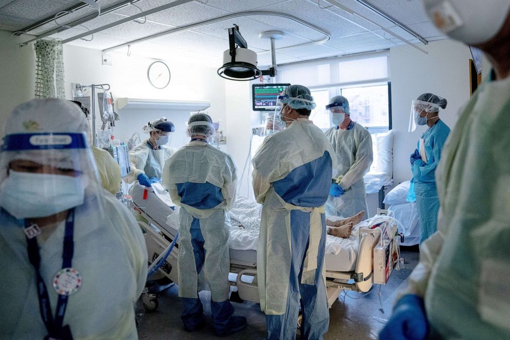 PHOTO: Doctors and nurses with a COVID-19 patient at Elmhurst Hospital in New York, May 8, 2020.