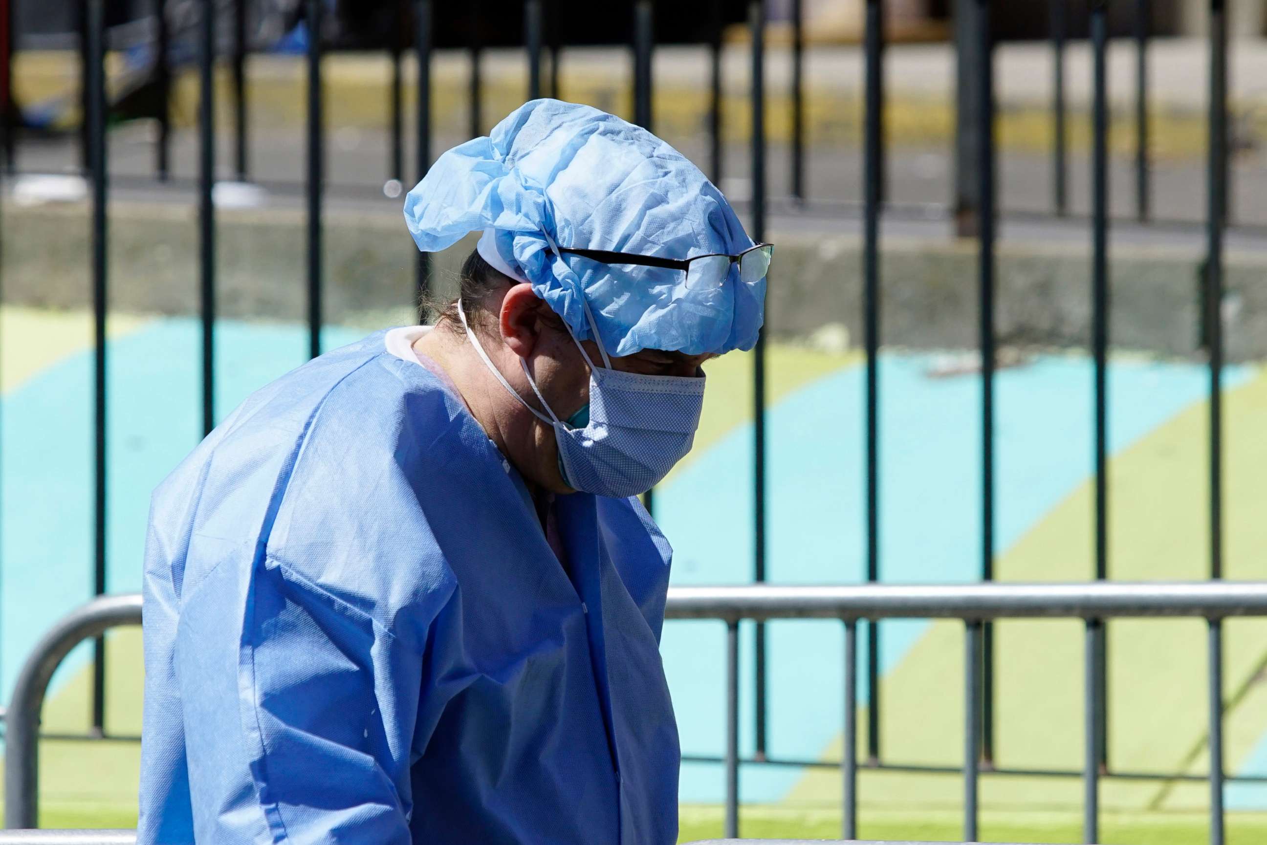 PHOTO: A healthcare worker in personal protective equipment (PPE) walks outside Elmhurst Hospital during the outbreak of the coronavirus disease (COVID-19) in the Queens, N.Y., April 6, 2020.