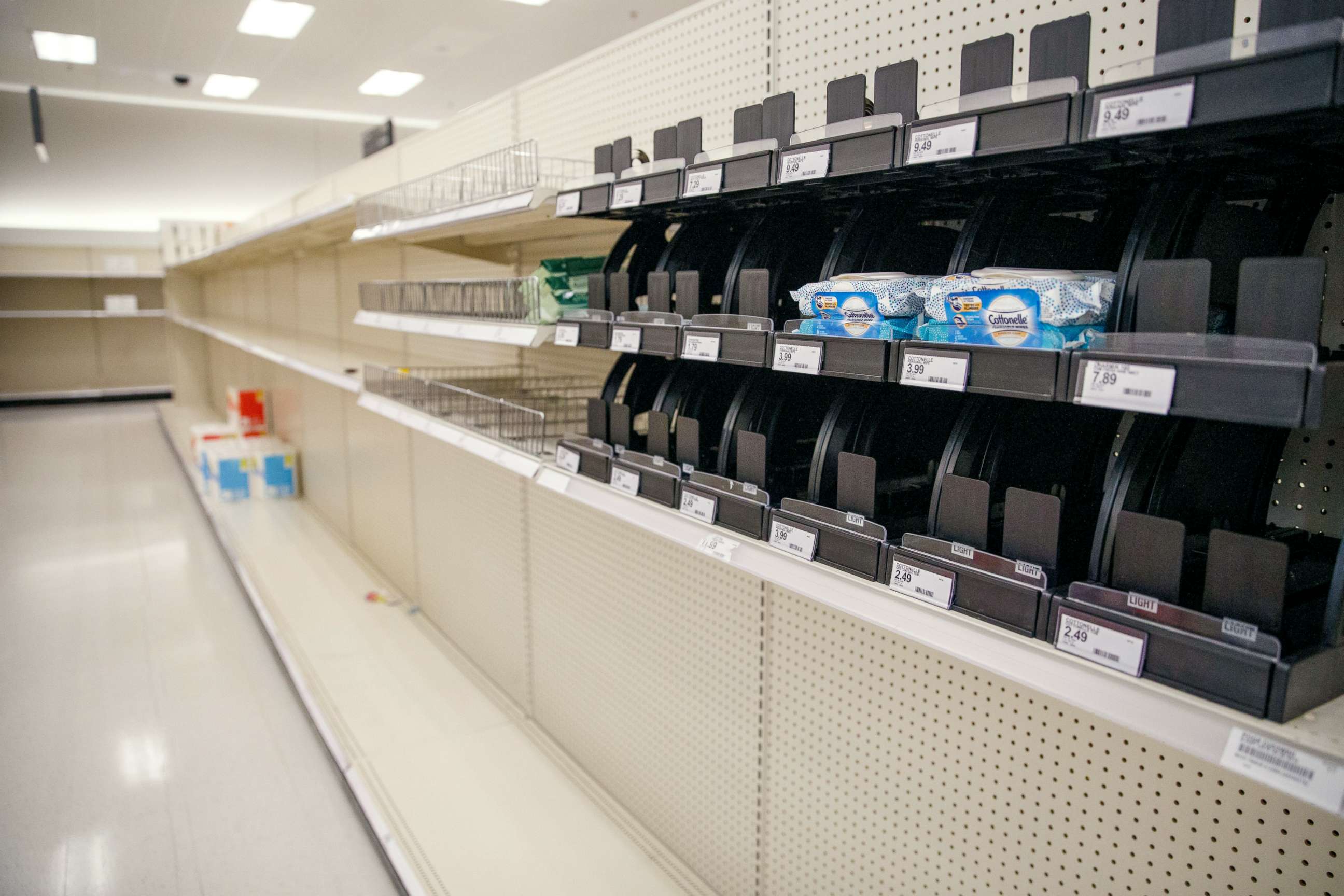 PHOTO: Shelves of paper products sit nearly empty at a Target in Alexandria, Virginia, March 12, 2020.