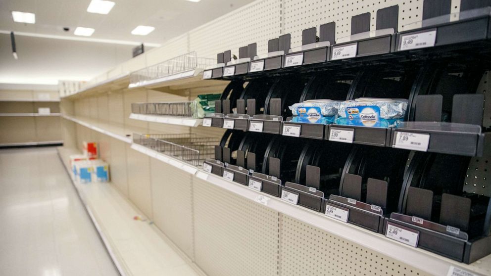 PHOTO: Shelves of paper products sit nearly empty at a Target in Alexandria, Virginia, March 12, 2020.
