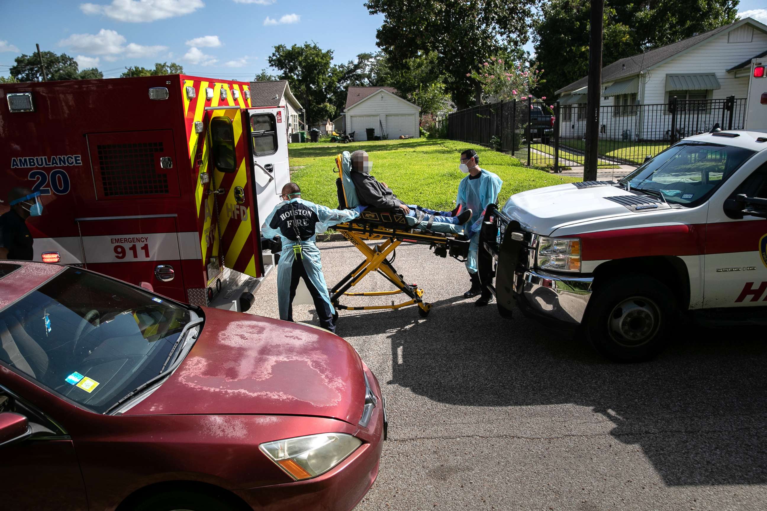 PHOTO: Houston Fire Department EMS medics load a possible COVID-9 patient into an ambulance for transport to the hospital on Aug. 13, 2020, in Houston.