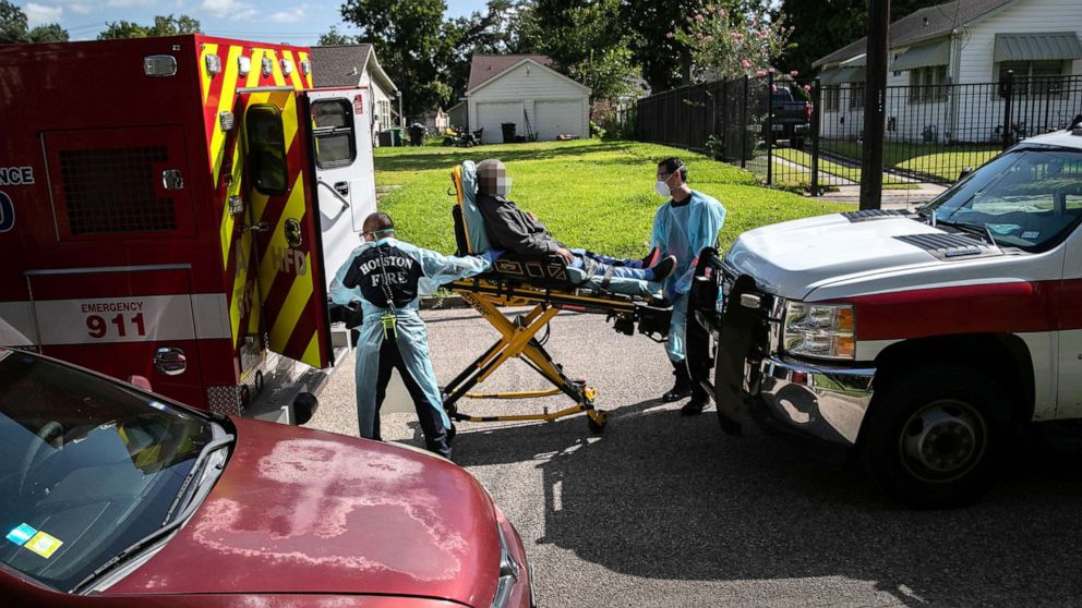 PHOTO: Houston Fire Department EMS medics load a possible COVID-9 patient into an ambulance for transport to the hospital on Aug. 13, 2020, in Houston.