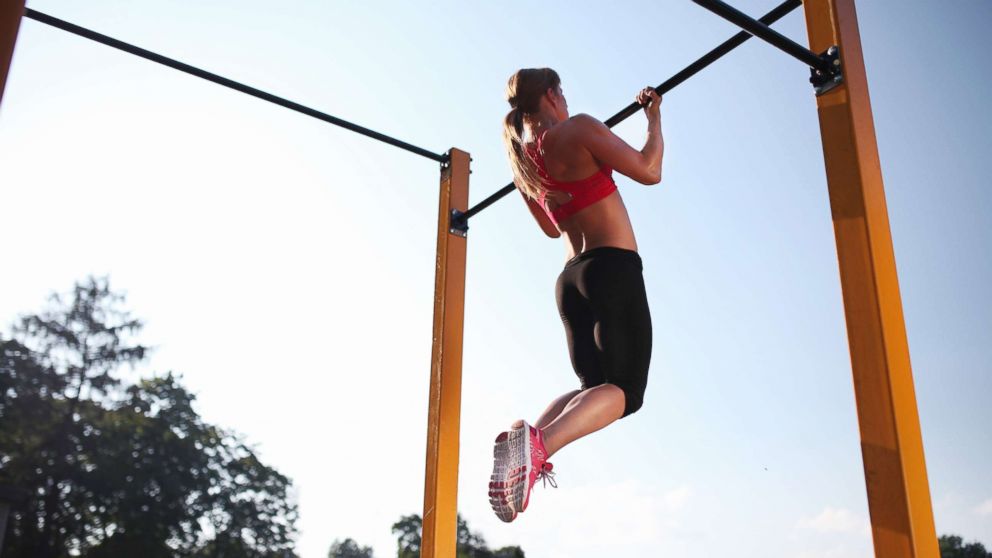 PHOTO: A woman trains on a chin up bar outdoors in this undated stock photo.