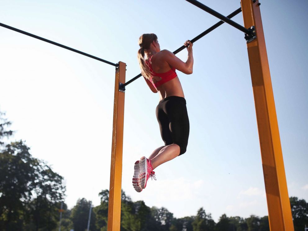 PHOTO: A woman trains on a chin up bar outdoors in this undated stock photo.