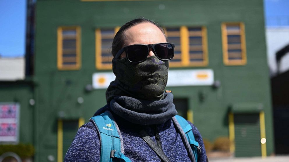 PHOTO: A woman with a face mask walks around the Greenpoint section of Brooklyn, New York, April 4, 2020.