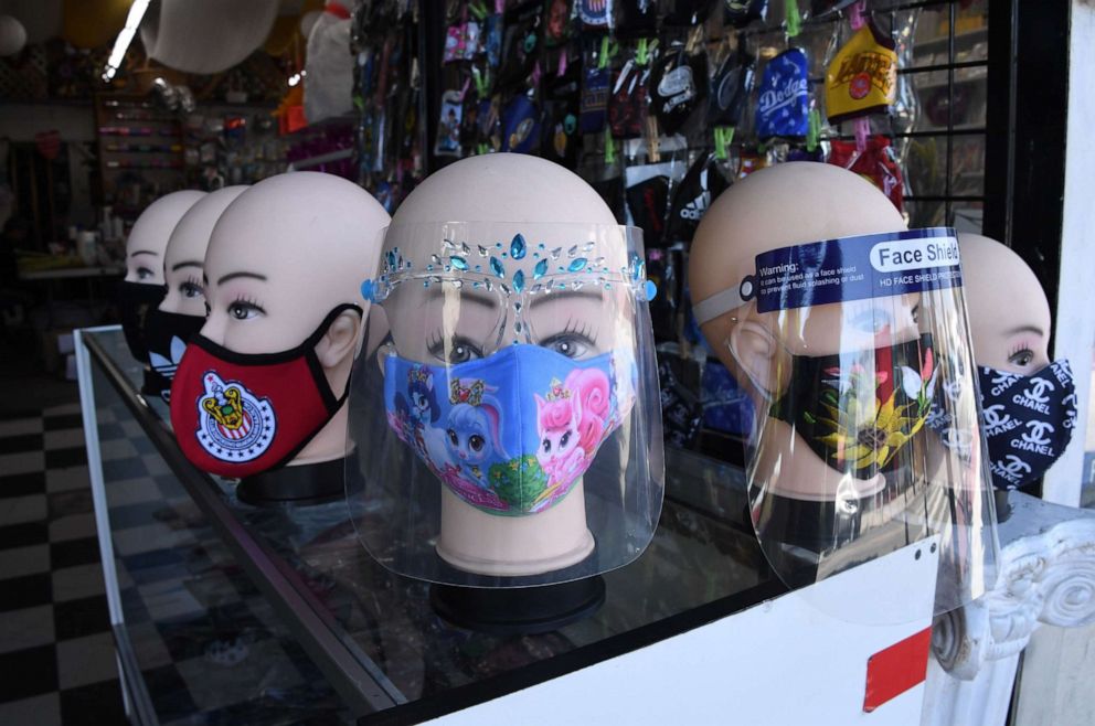 PHOTO: Masks and face shields are for sale in a flower shop in Los Angeles, Aug. 7, 2020.
