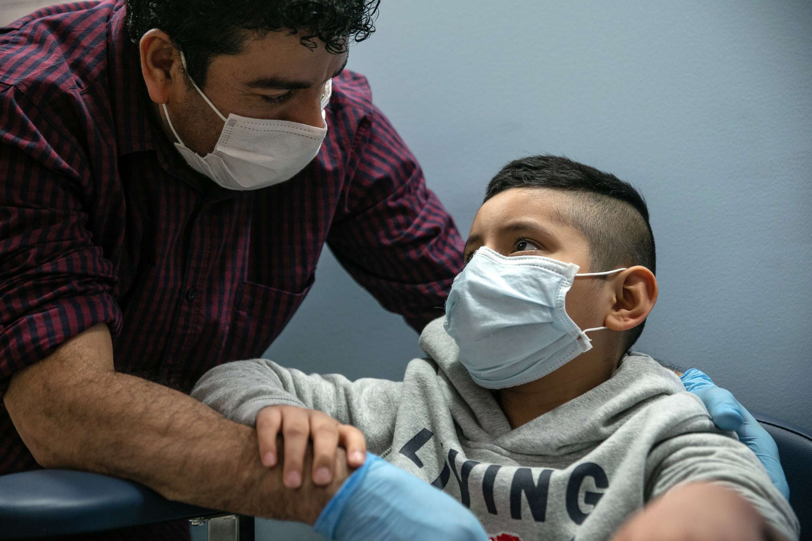 PHOTO: Guatemalan immigrant Marvin comforts his son Junior after a nurse drew blood for a COVID-19 antibody test at a clinic, May 5, 2020, in Stamford, Conn.