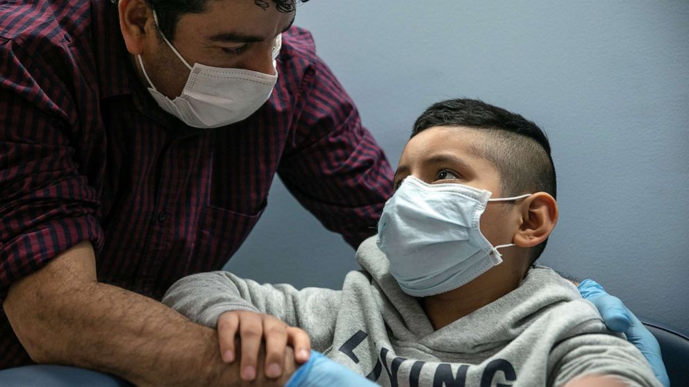 PHOTO: Guatemalan immigrant Marvin comforts his son Junior after a nurse drew blood for a COVID-19 antibody test at a clinic, May 5, 2020, in Stamford, Conn.