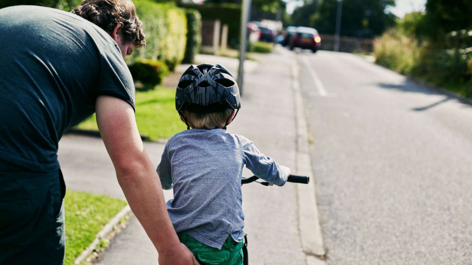 PHOTO: This stock photo depicts a father helping his son learn to ride a bike.