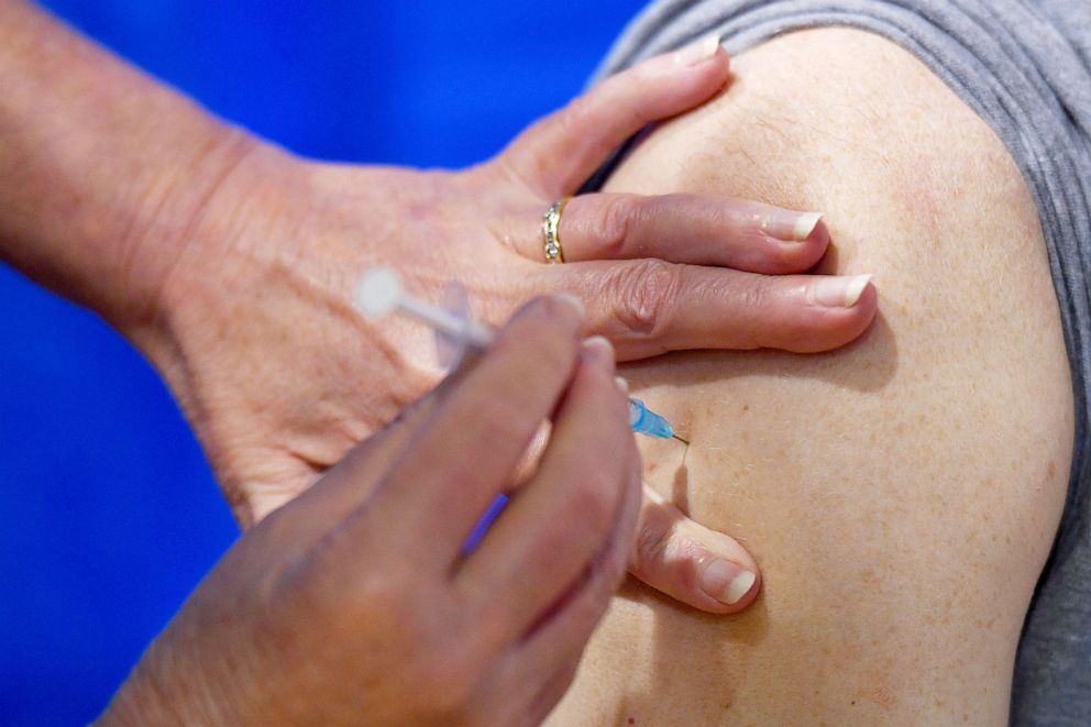 PHOTO: A nurse administers the Pfizer/BioNTech COVID-19 vaccine to a man at a vaccination center in Cardiff, Wales, Britain Dec. 8, 2020. 