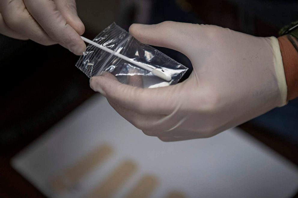 PHOTO: A swab is used to take an initial trace sample of the substance in the bag, before testing with the MX908.