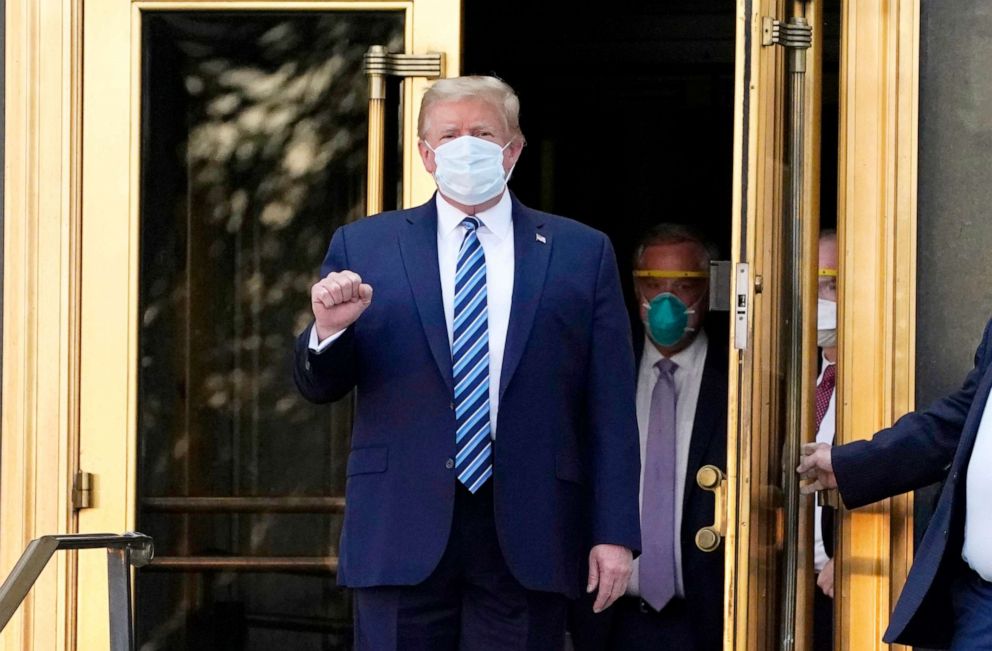 PHOTO: President Donald Trump walks out of Walter Reed National Military Medical Center to return to the White House after receiving treatments for COVID-19,  in Bethesda, Md., Oct. 5, 2020.