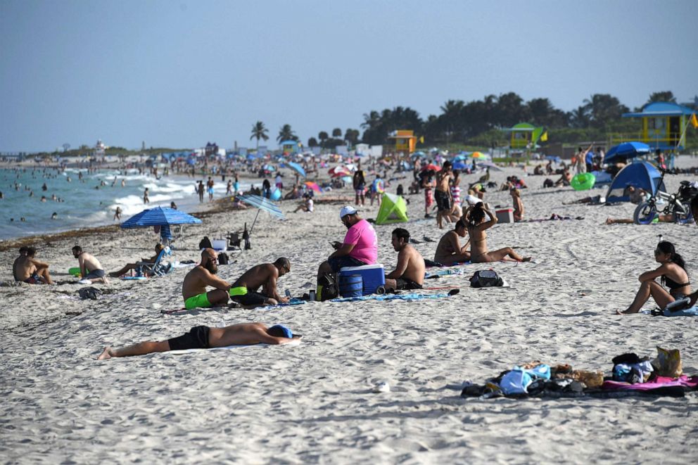 PHOTO: People are seen on Miami Beach, as Miami Dade County is mandating a daily 8 p.m. to 6 a.m. curfew, July 28, 2020.
