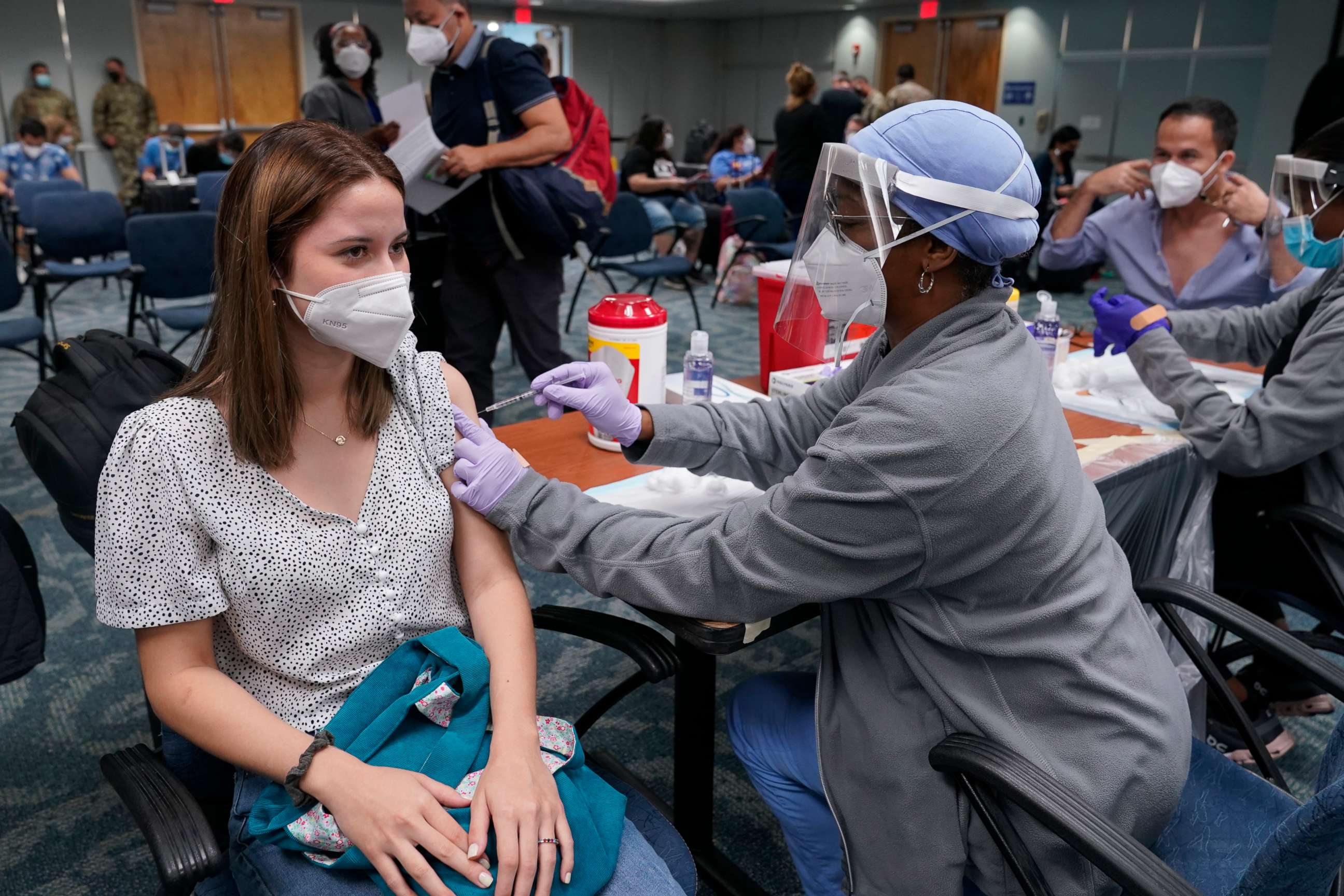PHOTO: Natalia Dubom, of Honduras, gets the Johnson & Johnson COVID-19 vaccine at Miami International Airport in Miami.