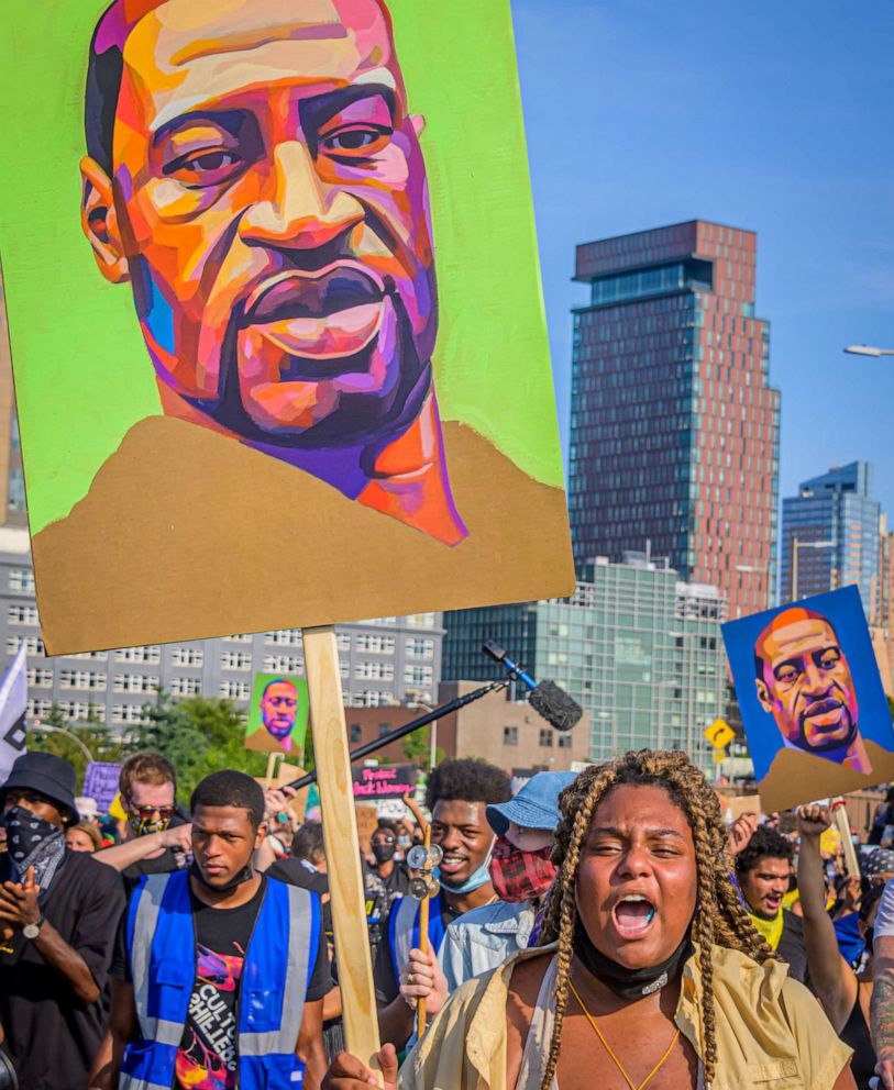 PHOTO: A portrait of George Floyd held by a participant taking the Manhattan inbound roadway at the march across the Brooklyn Bridge on July 25, 2020.