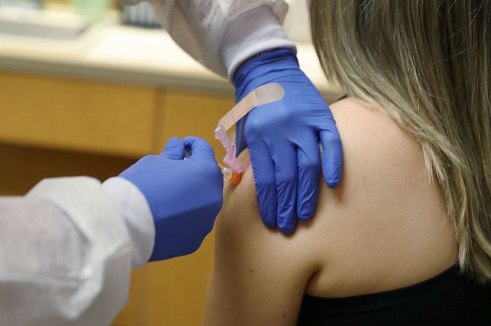 PHOTO: Enbal Sabag, a Nurse Practitioner, wears personal protection equipment as she administers a flu vaccination to Noel Janzen at the CVS pharmacy and MinuteClinic, Sept. 3, 2020 in Key Biscayne, Fla.