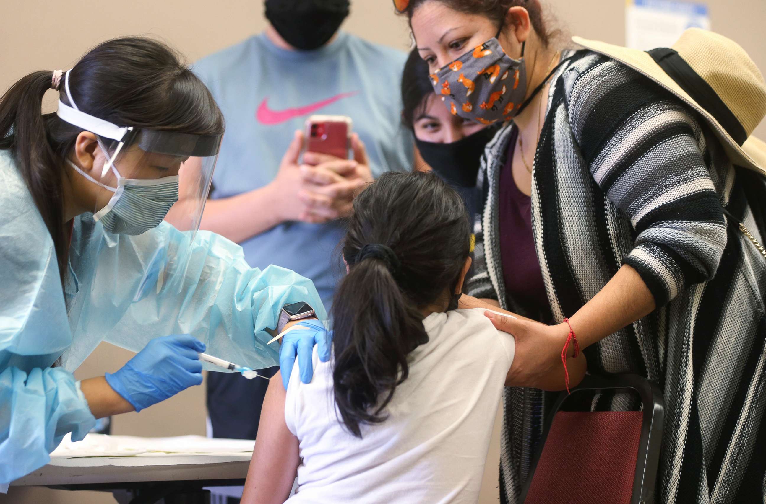 PHOTO: A child receives the flu vaccination shot from a nurse at a free clinic held at a local library on Oct. 14, 2020 in Lakewood, Calif.