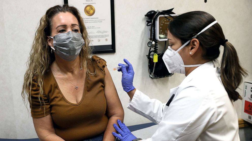 PHOTO: A nurse practitioner administers a flu vaccine to a patron at a CVS pharmacy and MinuteClinic, on Sept. 10, 2021 in Miami. CVS Health is offering the flu shots by appointment or walking in.