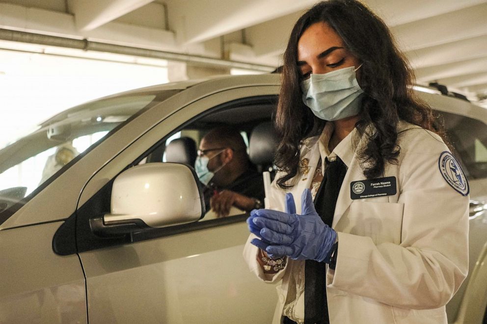 PHOTO: A medical worker prepares to administer a Flu vaccination at a drive through flu clinic held by Meijer at Comerica Park, Nov. 10, 2020 in Detroit, Michigan.