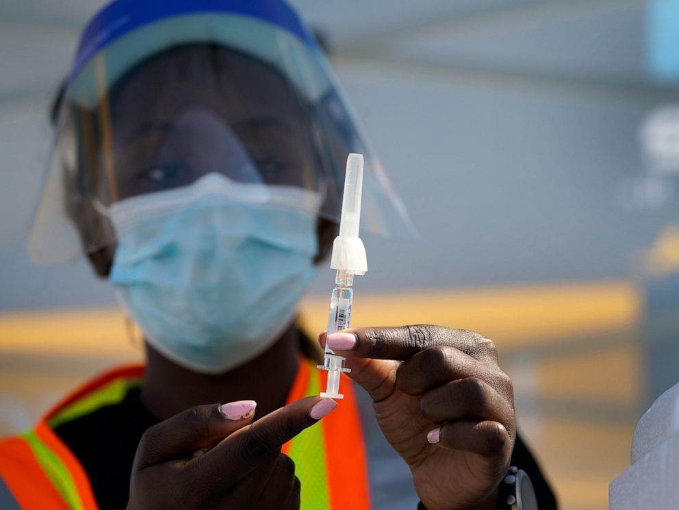 PHOTO: In this Saturday, Oct. 17, 2020, file photo, University of Southern California student pharmacist candidate Whitney Fakolade prepares a single doze of influenza vaccine in Los Angeles.