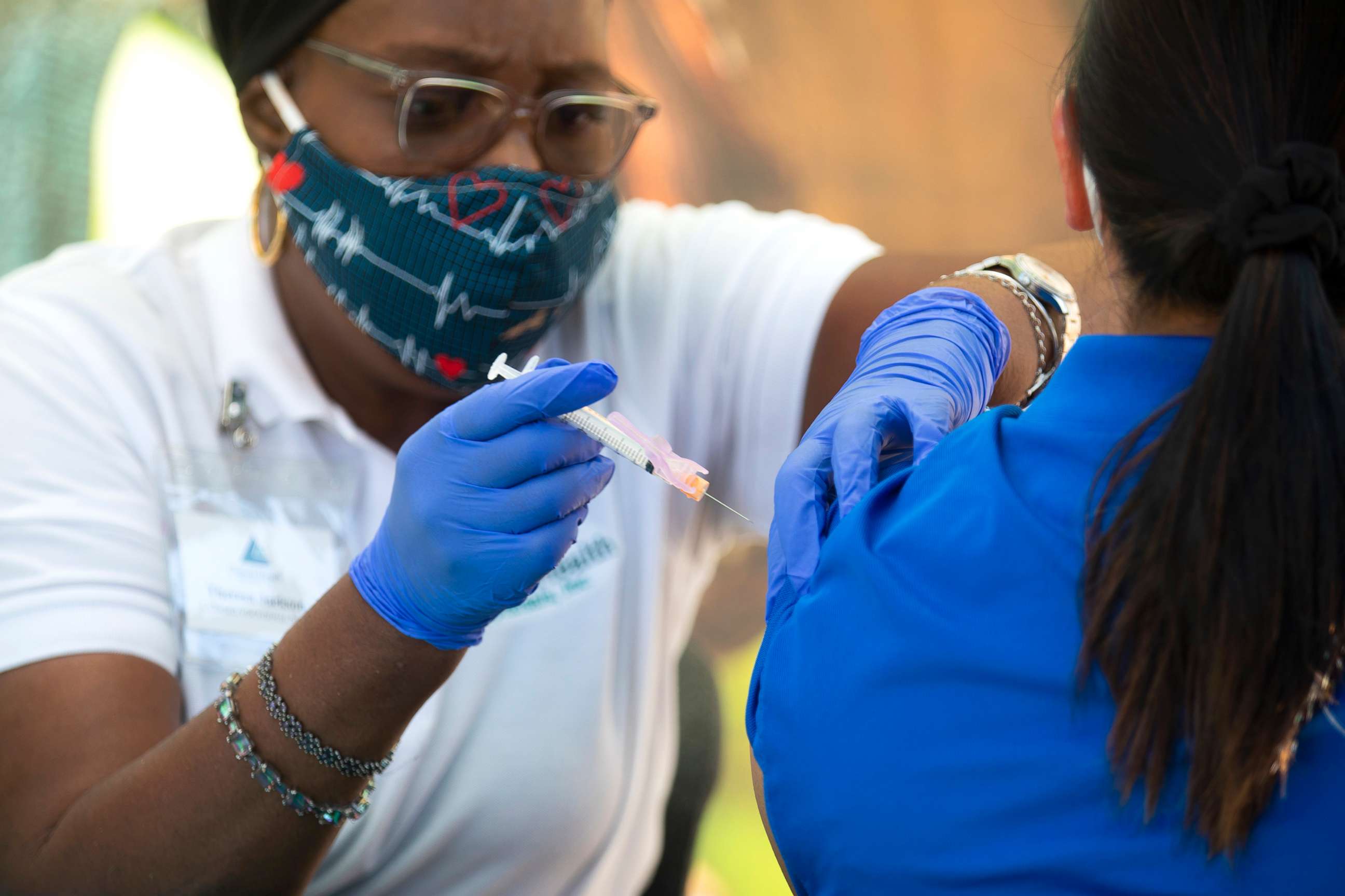 PHOTO:A Licensed Vocational Nurse Theresa Jackson, left, is pictured giving  flu shots at San Fernando Middle School, Oct.16, 2020 in San Francisco.