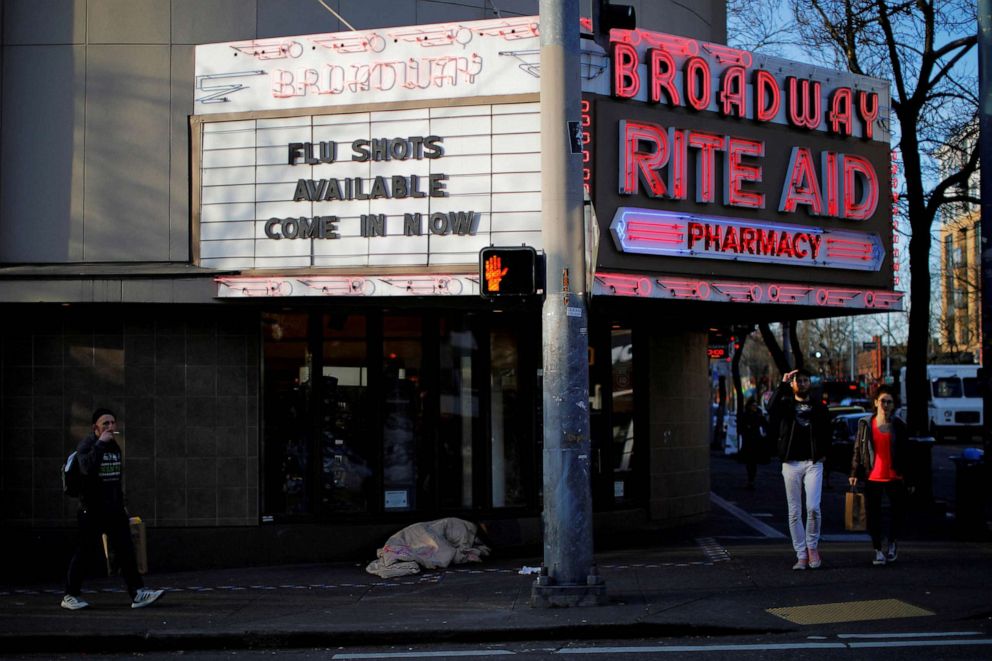 PHOTO: FILE PHOTO: The sign over a drug store advertises flu shots amid the coronavirus (COVID-19) outbreak in Seattle, March 17, 2020.