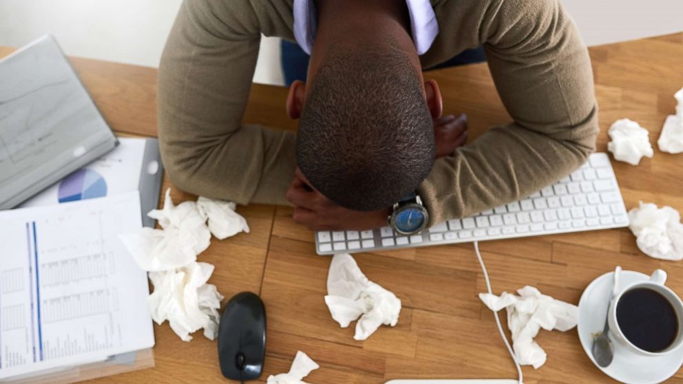 A man lays his head on his desk in this undated stock photo.
