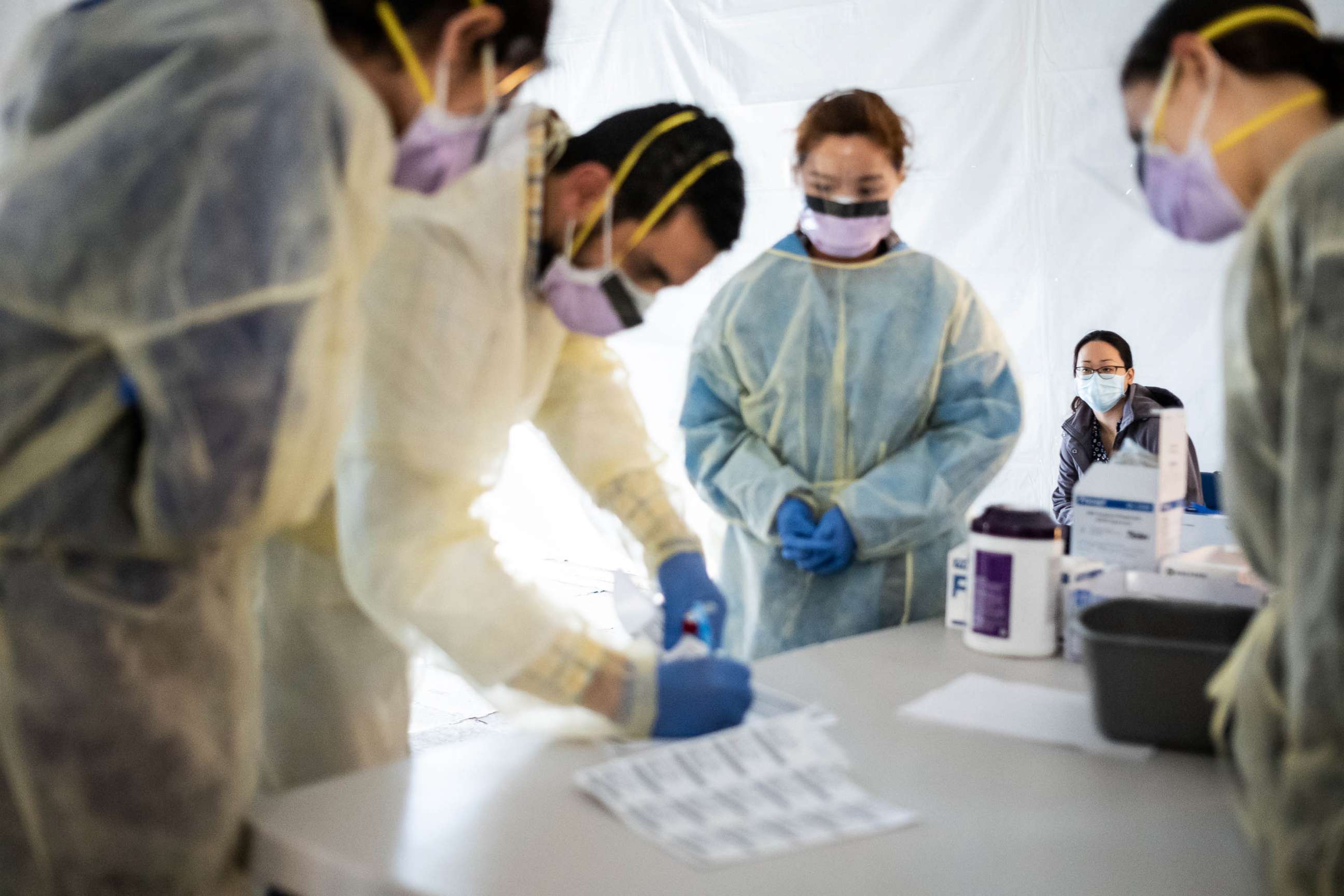 PHOTO: FILE - Doctors test hospital staff with flu-like symptoms for coronavirus (COVID-19) in set-up tents outside before they enter the main Emergency department area at St. Barnabas hospital in the Bronx, March 24, 2020 in New York City. 