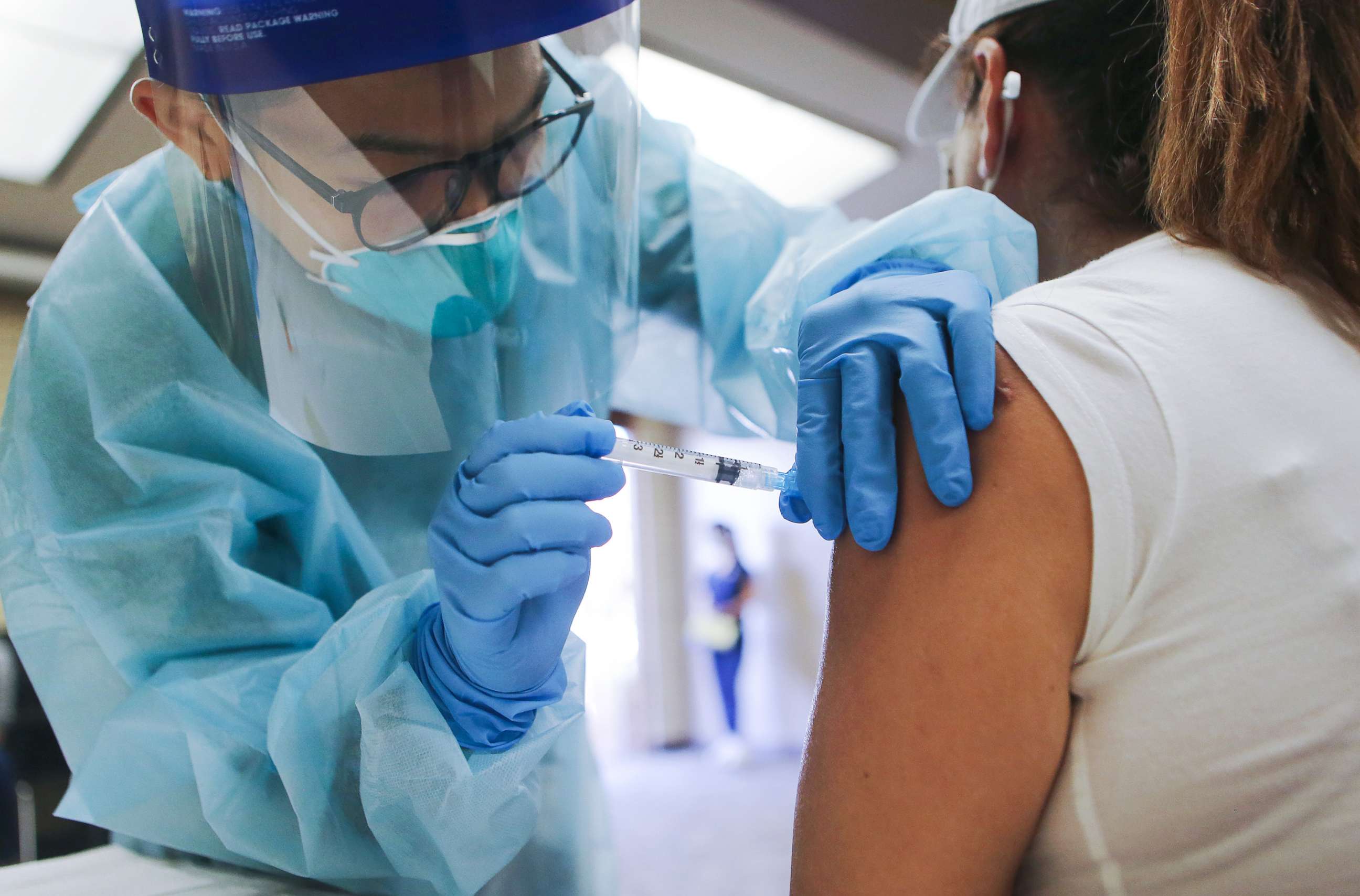 PHOTO: A nurse administers a flu vaccination shot to a woman at a free clinic, Oct. 14, 2020, in Lakewood, Calif. 