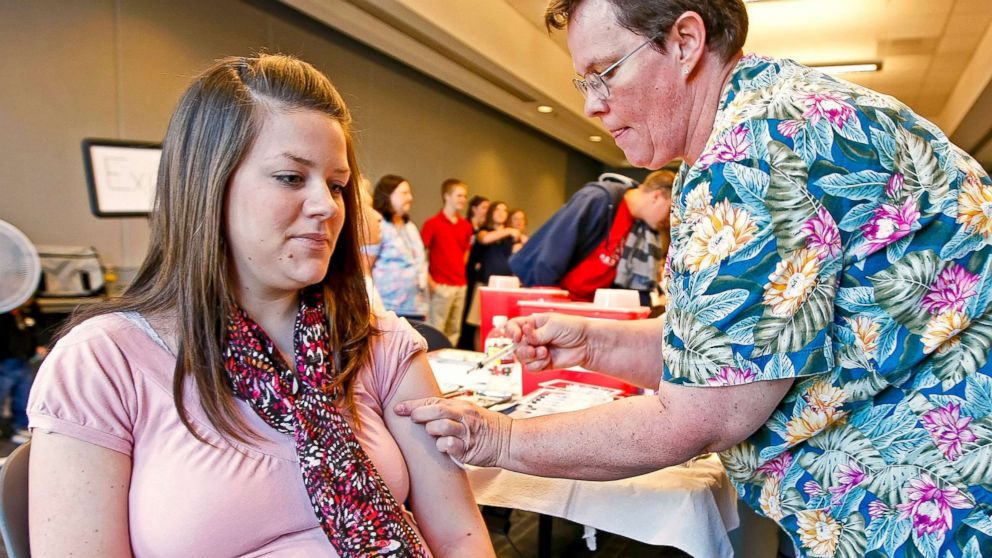 PHOTO: Nurse Laurel Apgood, right, administers a flu vaccine to Carrie Bard, who is pregnant and due in two weeks, at the Utah County Health Department in Provo, Utah, Nov. 3, 2009.