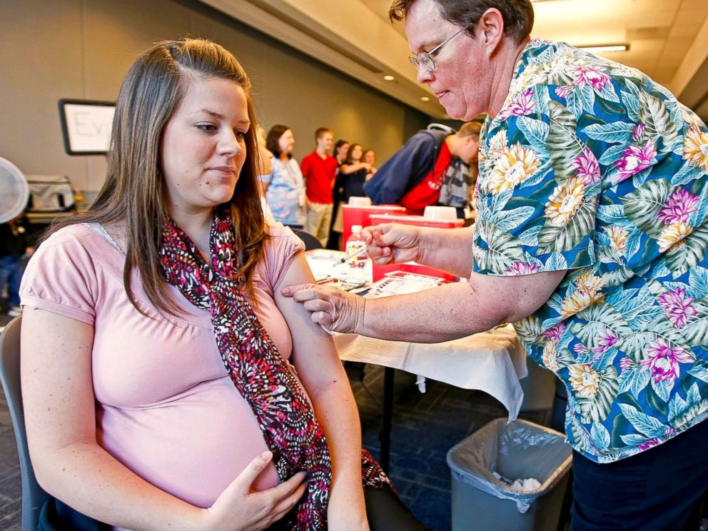 PHOTO: Nurse Laurel Apgood, right, administers an influenza vaccine to Carrie Bard, who is pregnant and expected in two weeks, at Utah County's Department of Health, in Provo, Utah, November 3, 2009.