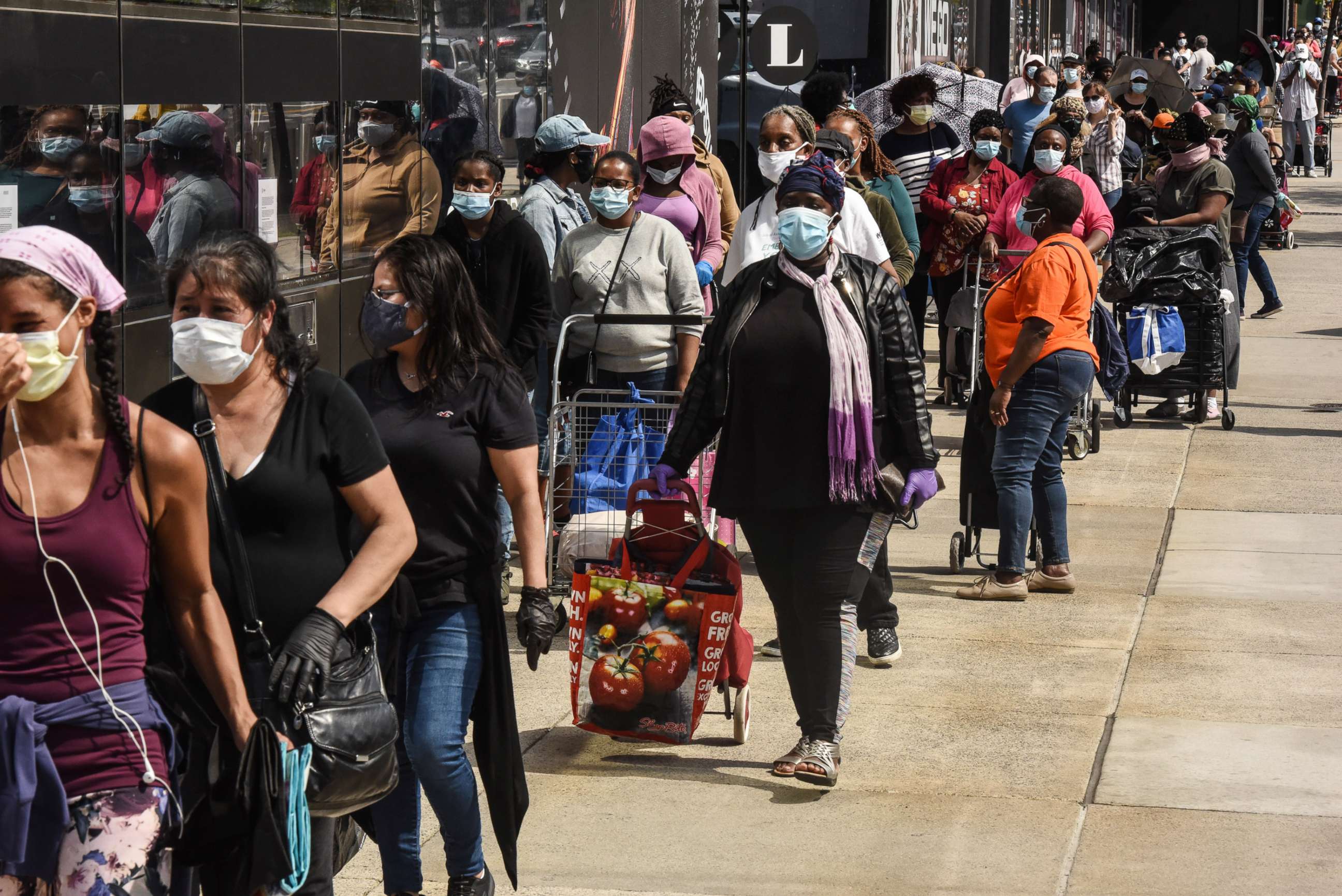 PHOTO: People wait on a long line to receive a food bank donation in the Brooklyn borough in New York, May 15, 2020.