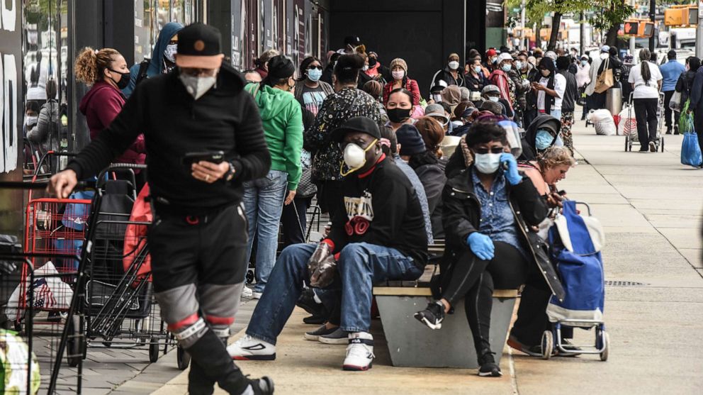 PHOTO: In this May 15, 2020, file photo, people wait on a long line to receive a food bank donation at the Barclays Center in Brooklyn, NY.