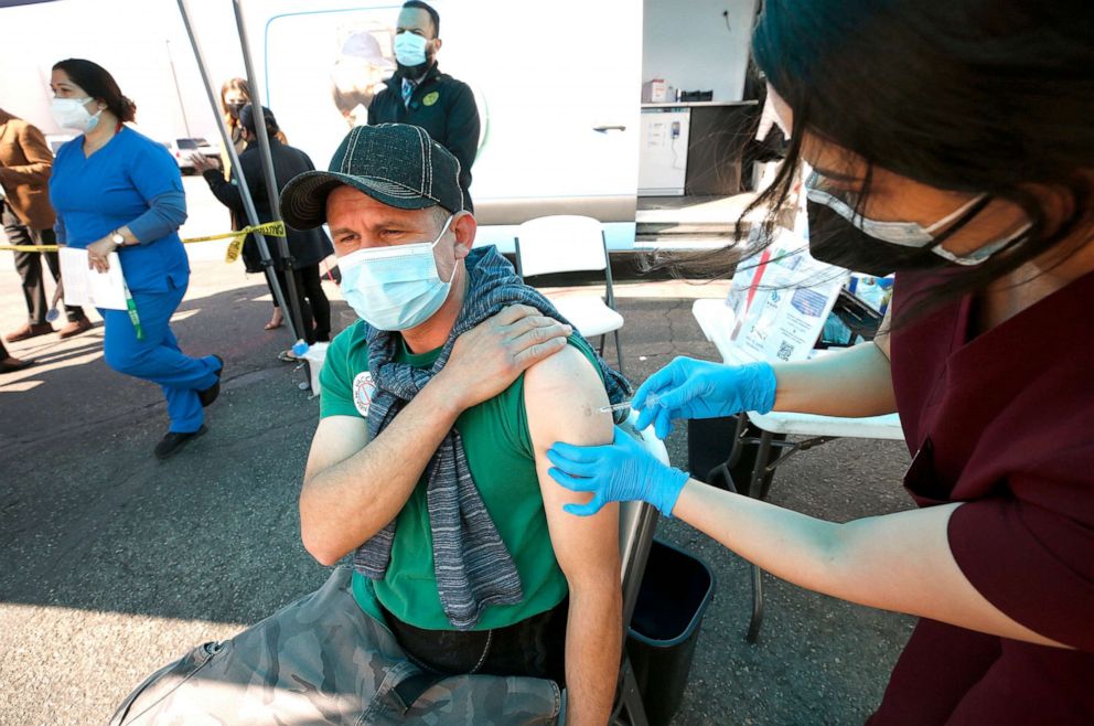 PHOTO: A worker receives the Pfizer vaccine as part of a city program to vaccinate essential food processing workers performing essential jobs in high-density work environments in Vernon, Calif., March 17, 2021.