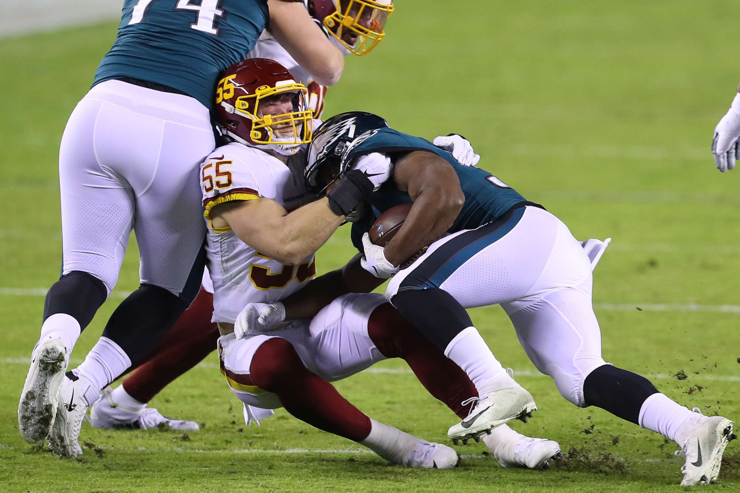 PHOTO: Linebacker Cole Holcomb of the Washington Football Team tackles running back Boston Scott of the Philadelphia Eagles during the first quarter of the game at Lincoln Financial Field on Jan. 03, 2021, in Philadelphia.