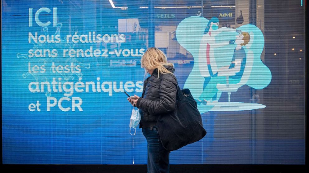 PHOTO: A person looks at a pharmacy window offering PCR and Antigen COVID-19 tests in Paris, Jan. 28, 2022.