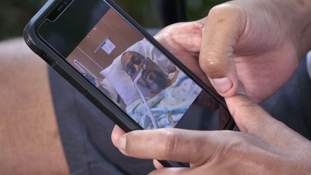 PHOTO: Joshua Garza looks at photos of himself when he was severely ill with COVID-19 in early 2021, in Sugarland, Texas, on June 16, 2021.