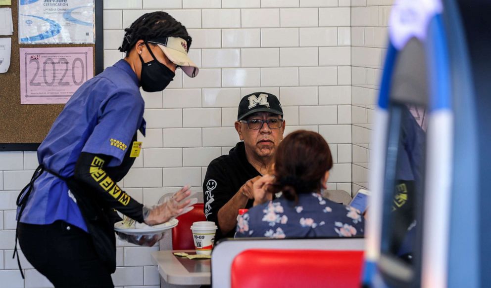 PHOTO: A Waffle House employee serves customers on April 27, 2020, at The Waffle House in Brookhaven, Ga.